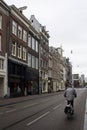 View of man riding bicycle on one of the shopping streets