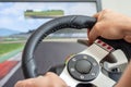 Man's hands playing a racing simulator on a steering wheel Royalty Free Stock Photo