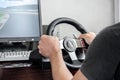 Man's hands playing a racing simulator on a steering wheel Royalty Free Stock Photo