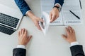 View of man taking envelope with cash near business partner and laptop Royalty Free Stock Photo