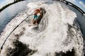 View of man wakesurfer who rides along wave on board