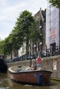 View of man and woman in a boat on canal