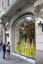 View of man and woman in front of famous, French luxury brand`s store on street called