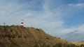 View of Mancora lighthouse over the mountain during a cloudy day