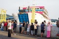 View of many people watching a ferry docking at Merak harbor in the afternoon Royalty Free Stock Photo
