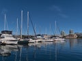 View of marina with docking yacht boats reflected in water of Victoria\'s Inner Harbour on sunny day with skyline. Royalty Free Stock Photo