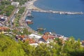 View of the Turkish resort town of Alanya from a height through the coniferous thickets.