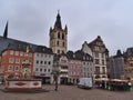View of marketplace Hauptmarkt with weekly market in the historic center of Trier on cloudy summer day.
