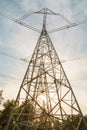 View of the masts of the power line against the background of blue sky, white clouds, beautiful forest i Royalty Free Stock Photo