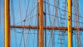 View of the masts and rigging of a sailing ship closeup against the summer sky