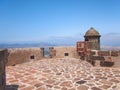 View from mediaeval fortress wall on hilltop. Mountains and volcanoes on deep blue horizon Royalty Free Stock Photo