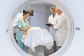 View medical team through circular mri scanner Royalty Free Stock Photo