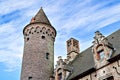 View of the Medieval brickwork tower under the clouds of blue sky in Belgium Royalty Free Stock Photo
