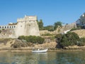 View of medieval fort Forte de Sao Clemente over the Mira river with small boat in sunny day with clear blue sky. Vila Royalty Free Stock Photo