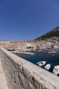 View of the medieval Old Port by Adriatic Sea with moored ships and City Walls, Dubrovnik, Croatia Royalty Free Stock Photo