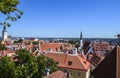 View of medieval old town with tiled red roofs, St. Olaf Baptist Church and Church of the Holy Spirit. Tallinn Royalty Free Stock Photo