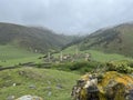 View of the medieval Targim tower complex in the Caucasus mountains surrounded by greenery. The Caucasus Mountains on a Royalty Free Stock Photo