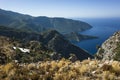 View of Mediterranean sea coast from Lycian way hiking trail high on mountain near small turkish village Alinca