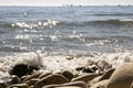 View of the Mediterranean Sea, large stones on the shore. In the background are ships and sailboats. sunny day. View of