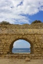 View of the Mediterranean Sea through a stone arch