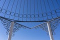 View on metal gazebo above blue sky on sunny summer day, closeup