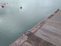 View of metallic bollard with black rubber wheel attached on Caribbean sea pier.