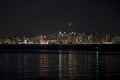 View of metro San Diego from Shelter Island at night with reflection of lights in the water