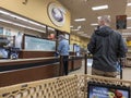 Kirkland, WA USA - circa October 2021: View of an middle aged man picking up a prescription at a pharmacy inside a Safeway grocery Royalty Free Stock Photo