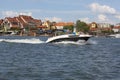 View from MikoÃâajskie Lake of town, motorboat sailing on the lake, Mikolajki, Masuria, Poland