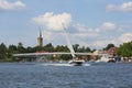 View from MikoÃâajskie Lake of town, motorboat sailing on the lake, Mikolajki, Masuria, Poland