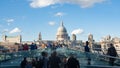 View of the Millennium bridge in London with St Paul cathedral and tourists