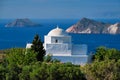 View of Milos island and Greek Orthodox traditional whitewashed church in Greece