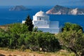 View of Milos island and Greek Orthodox traditional whitewashed church in Greece