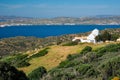 View of Milos island and Greek Orthodox traditional whitewashed church in Greece