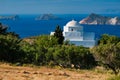 View of Milos island and Greek Orthodox traditional whitewashed church in Greece