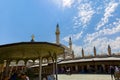 View of the minarets of the Konya Mevlana Tomb extending from the courtyard of the Sultan Selim Mosque to the blue sky.