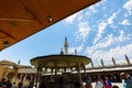View of the minarets of the Konya Mevlana Tomb extending from the courtyard of the Sultan Selim Mosque to the blue sky.