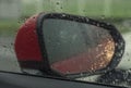 View mirror from inside of car on raining day with rain drop Royalty Free Stock Photo