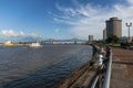 View of the Mississippi river with boats from the city of New Orleans riverfron, with the Great New Orleans Bridge on the backgrou