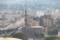 View of misty of city of Cairo in Egypt, due to traffic pollution, over rooftop slums and mosques