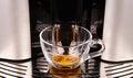 View on modern automatic coffee maker machine with  transparent glass cup filled with cafe crema Royalty Free Stock Photo