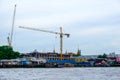 View of modern building construction hotel and giant cranes on t