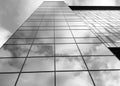 View of a modern glass skyscraper. A reflection of the cloudy sky in a glass skyscraper. Black and white photo Royalty Free Stock Photo