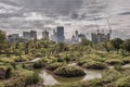 View of Modern high buildings among green trees space in nature park against blue sky with clouds at afternoon Royalty Free Stock Photo