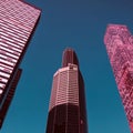 View through modern high rising skyscraper upwards to blue sky