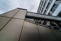 View through modern high rising skyscraper upwards to blue sky with white clouds - abstract architecture detail background Royalty Free Stock Photo