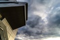 View through modern high rising skyscraper upwards to blue sky with white clouds - abstract architecture detail background Royalty Free Stock Photo