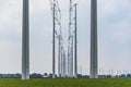 A view between the modern high voltage pylons in the meadows near Alphen aan de Rijn, the Netherlands