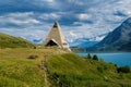 Pyramid shaped church, alpine lake of Mont-Cenis and mountains on background in France