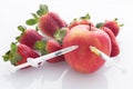 View of the Modified food concept / strawberries with punched needles and syringes Royalty Free Stock Photo